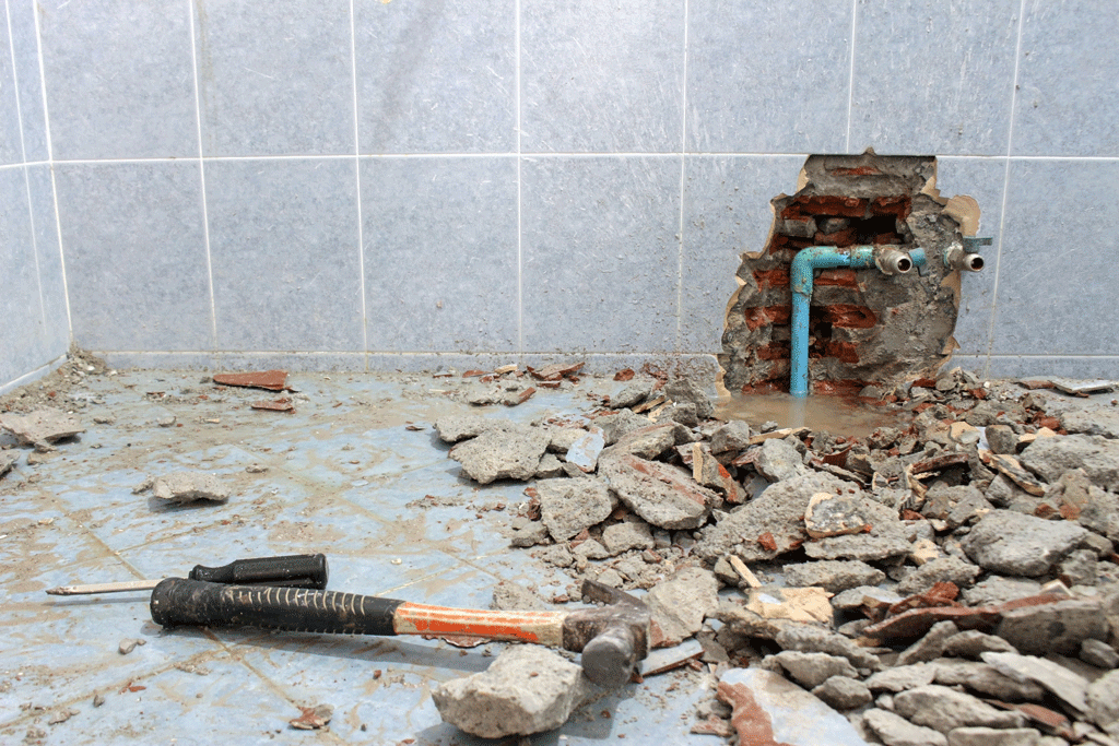hole in wall with tools on floor | whole house repipe katy tx sugarland tx 