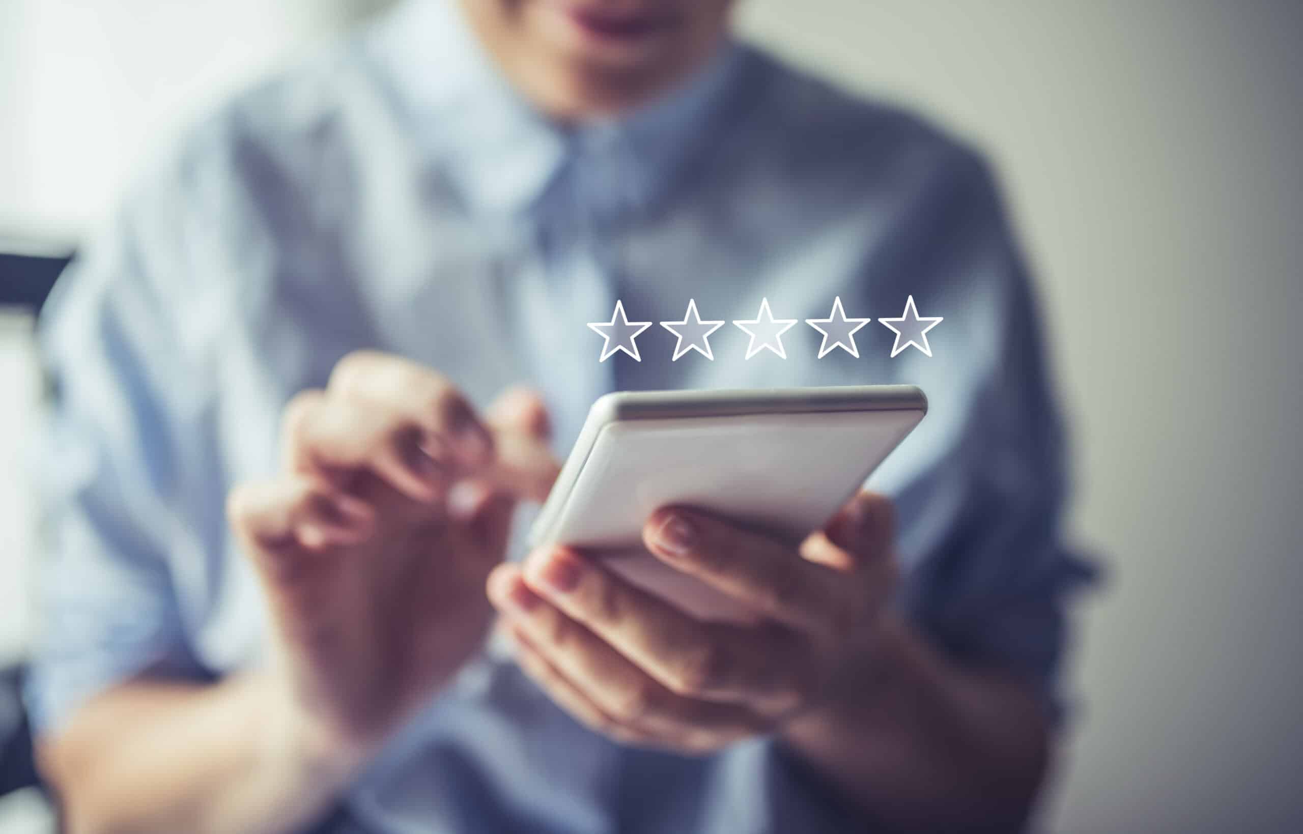 A woman is using her phone to give a five-star and good review for bluefrog Plumbing + Drain of West Houston