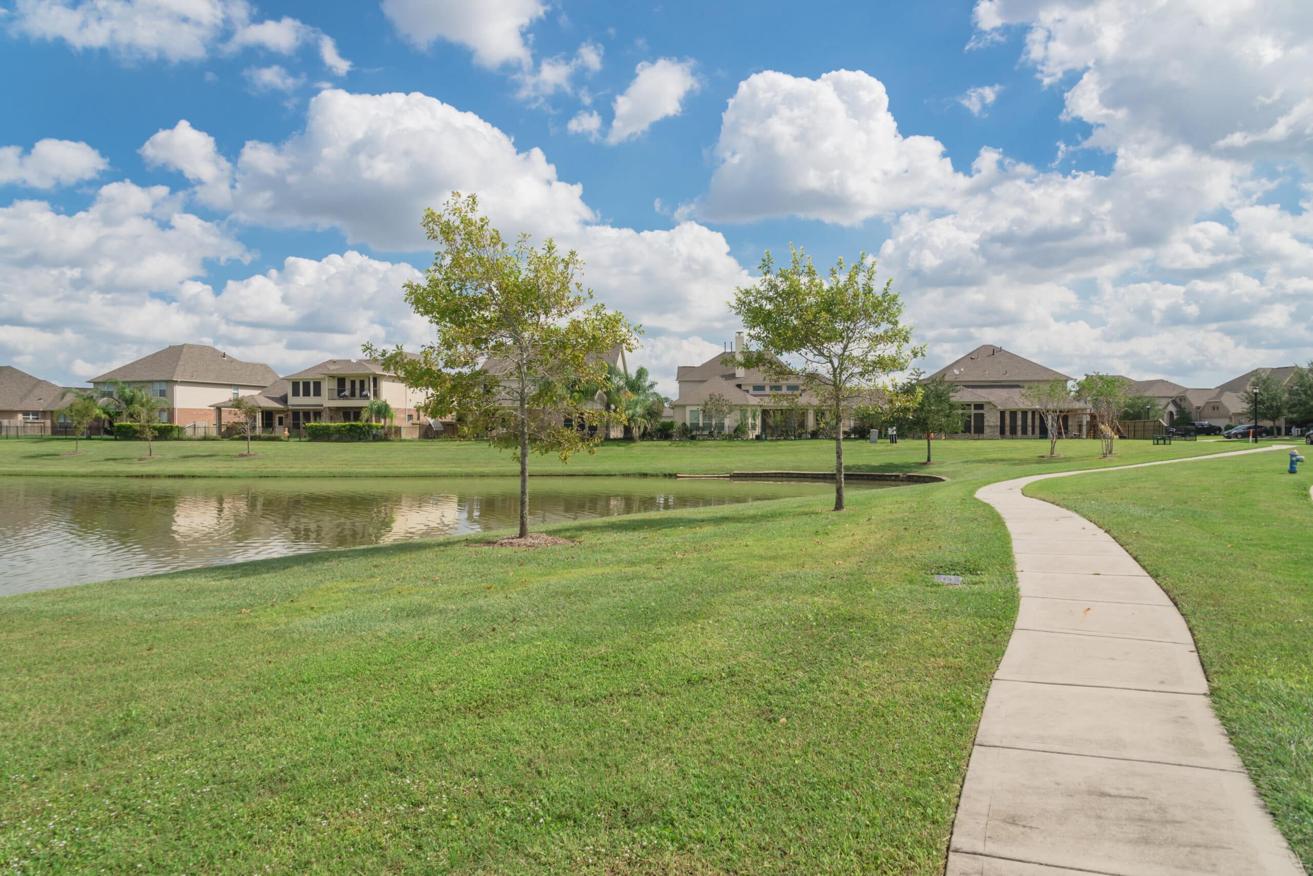 The walking pathway alongside leads to residential houses by the lake in Pearland, TX, USA. Plumber In Pearland, TX.